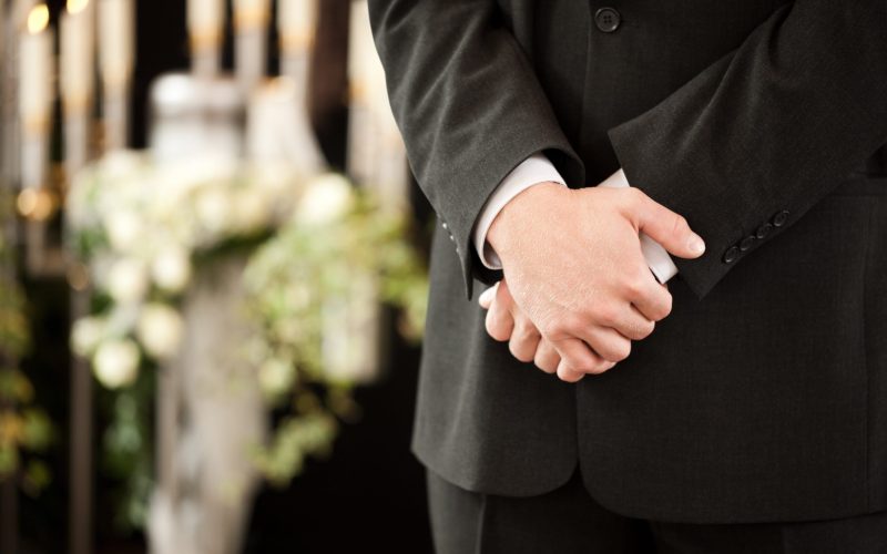 Man standing at funeral